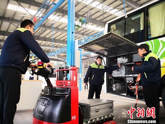 圖為工作人員在給新能源車輛安裝蓄電池?！∥航ㄜ?攝